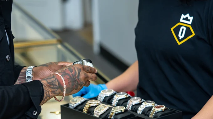 A customer viewing watches with a QueenCity team member
